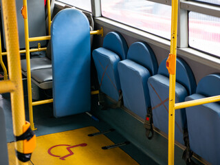 Fototapeta premium Wheelchair accessible space and designated area for disabled passengers on public transportation bus or train - barrier-free inclusive transit design.
