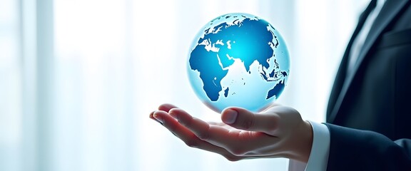 A person in a suit holding a glowing blue globe in their hands, symbolizing global business and connection
