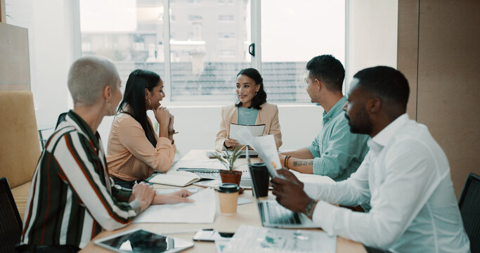 Creative, team or planning with paperwork in office for editorial guidance, story ideas or advice. Publishing agency, people and editor with discussion in meeting for news feedback and review topics
