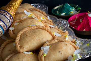 Gujhiya, Indian fried sweet with dry fruits and fancy decorative background