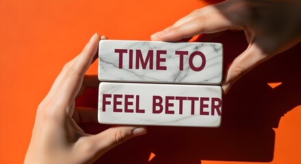 Hands present 'time to feel better' on marble blocks, offering a message of positivity and well-being.