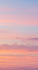 Fototapeta premium A breathtaking sunset sky, painted with soft pinks, oranges, and blues, displays a beautiful palette of colors and a serene mood.