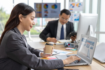 ian businesswoman working with computer laptop and mobile phone in a modern office during a typical workday, representing multitasking, digital communication, and professional lifestyle in a corporate