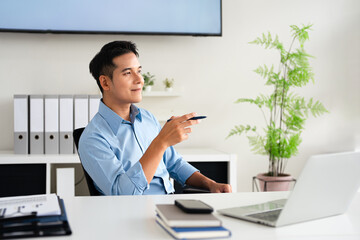 young successful man, businessman, freelancer, designer in the office confidently looking to the...