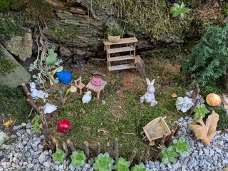 Public children’s garden filled with fairy tale characters, animals, and moss-covered houses, creating a magical storybook atmosphere in a natural outdoor setting.