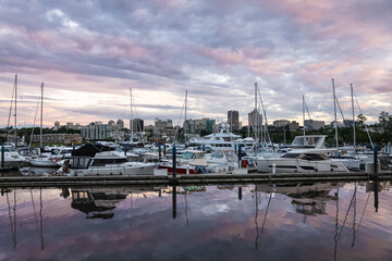 Beautiful sunset view of yacht harbor and sailboat at dock with wonderful sunset sky.