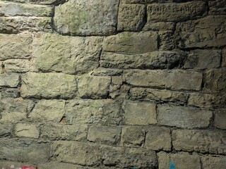 Textured stone patterns on walls of old railway tunnel in Central Europe