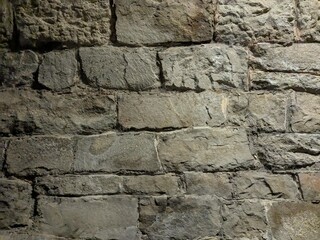 Textured stone patterns on walls of old railway tunnel in Central Europe