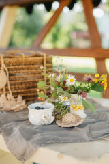 Delicate Floral Arrangement and Berries on a Rustic Table Setting