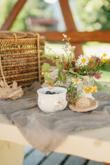 Delicate Floral Arrangement and Berries on a Rustic Table Setting