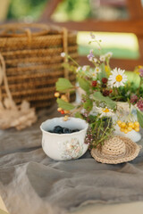 Delicate Floral Arrangement and Berries on a Rustic Table Setting