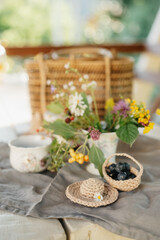 Delicate Floral Arrangement and Berries on a Rustic Table Setting