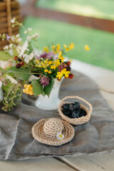 Delicate Floral Arrangement and Berries on a Rustic Table Setting
