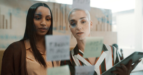 Business, women and brainstorming by glass with tablet for research, sticky note and team discussion. Info, schedule or agenda with female people planning, partner and tech for project management