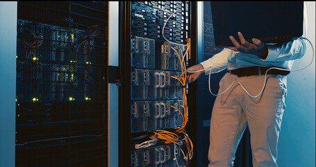 Hands, laptop and system test in server room for diagnostics, troubleshooting and maintenance. Engineer, cables and tech in data center for network configuration, firewall installation or IT solution