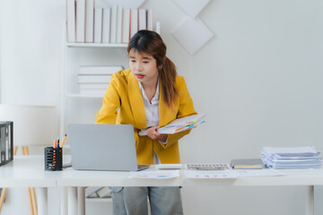 Focused Professional at Work: A portrait of a dedicated professional woman, engrossed in her tasks,...