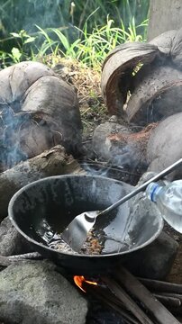 Cooking mie nyemek in a rice field with traditional outdoor style and rustic countryside atmosphere. Indonesian noodle dish prepared in a natural rural environment, showcasing local culinary culture, 
