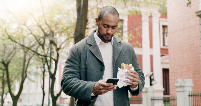 Business, man and phone with food for travel in city, browsing social media and lunch break. Male person, reading and mobile with healthy meal, direction search and notification update for urban trip
