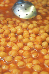 Chickpeas simmering in rich sauce at local market stall