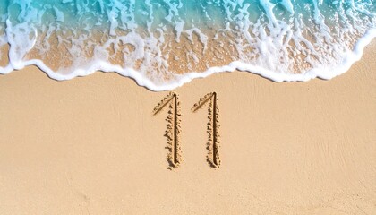 Number Eleven and Twelve Written in Sand on Beach with Ocean Waves in Background