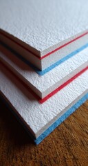 Fototapeta premium Close-up of layered white paper with red and blue borders