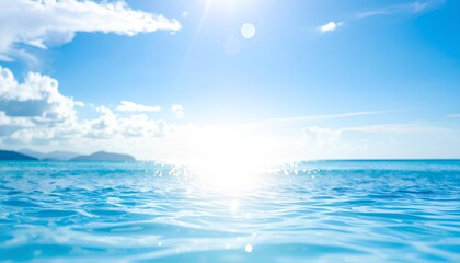 Obraz premium A beautiful view of the sea horizon with sparkling blue water and bright sunlight, under a clear summer sky. Perfect for backgrounds, travel, holidays, and nature concepts.