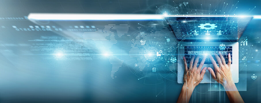 Manager using a laptop with ERP data financial modules, supply chain integration, HR processes, inventory control, reporting dashboards, and business resource planning.