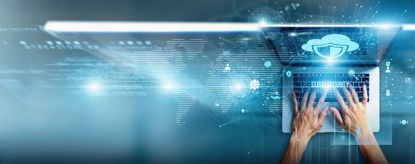 Cybersecurity specialist using a laptop with cloud security data encryption layers, threat detection, compliance monitoring, identity management, firewall integration, and intrusion prevention.