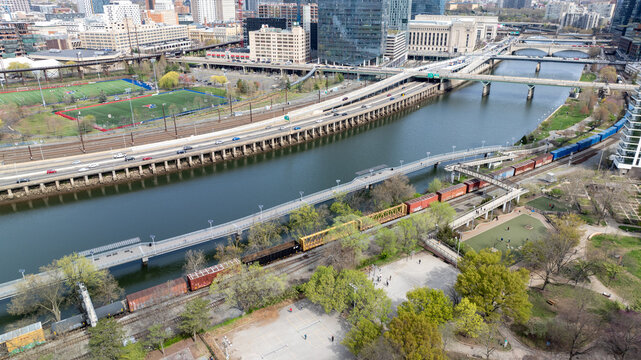 Aerial view of Schuylkill River snaking through the city, with bridges and trains adding linear elements against the urban backdrop, Philadelphia, Pennsylvania, United States.