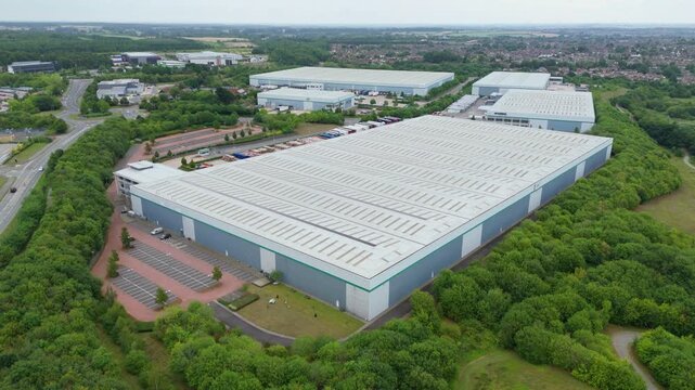 High up aerial drone shot of modern warehouse and logistics distribution centre with bays Kettering England UK