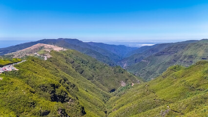 Naklejka premium Scenic view of green mountains and hills from the subtropical Laurissilva forest in Rabacal, Madeira Island, Portugal, Europe. Drone view. High quality photo