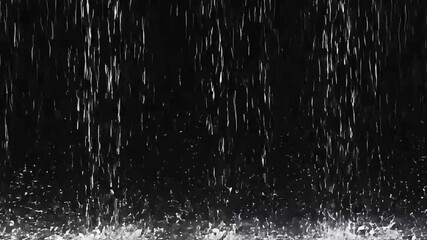 Heavy rain falling intensely against a dark, contrasting background, creating a dramatic and powerful display of a downpour with numerous water splashes - Powered by Adobe