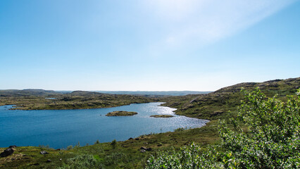 landscape Russian North view in the tundra with a mountain river and a lake in the mountains