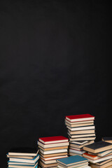 Stacks of educational books for learning on a black background