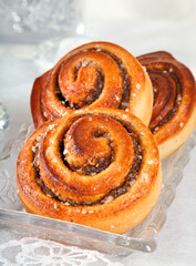 Cinnamon buns close-up on  stylized winter's backgrounds.