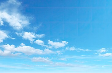 Bright blue sky with scattered white clouds