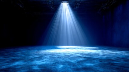 Blue spotlight shining on a dark stage with light effects