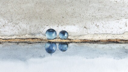 Two blue orbs sit on a textured landscape, reflected in a calm body of water