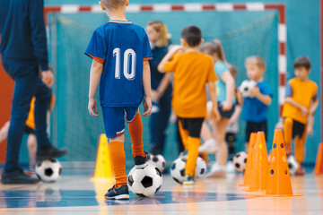 Football futsal training for children. Sport background. Soccer training dribbling cone drill. An...