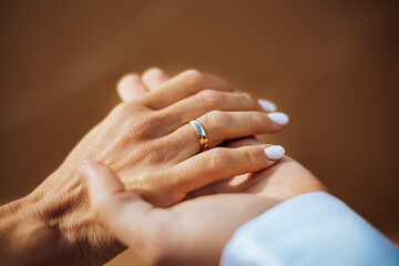 Close-up of bride’s hand with wedding ring gently held, symbolizing love, unity, and lifelong commitment in a romantic and intimate wedding moment