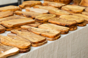 Olive wood cutting boards displayed on table at Nyons market in France