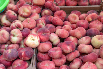 Fresh Flat Peaches Filling Cardboard Boxes at a French Market in Nyons
