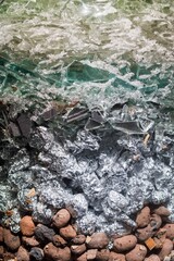 Layered Abstract Texture. Glass Shards, Crumpled Aluminum Foil, and Natural Stones Composition.