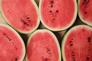 Close-up shot of half pieces of fresh red watermelons on a wooden background, natural texture...