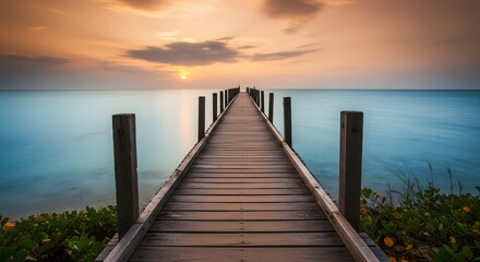 Obraz premium Wooden pier at sunset over water