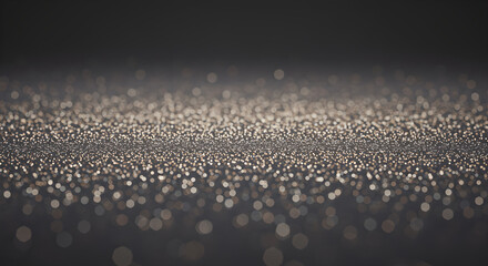 Abstract shimmering golden bokeh lights on a dark background creating a magical, festive, and luxurious texture