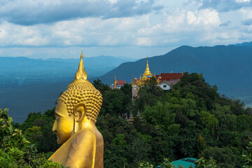 Front view of red floodgate dam with strong water release.