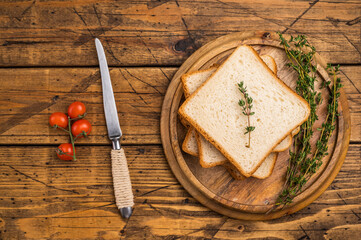 Ready for toasts Slices of wheat bread. wooden background. top view