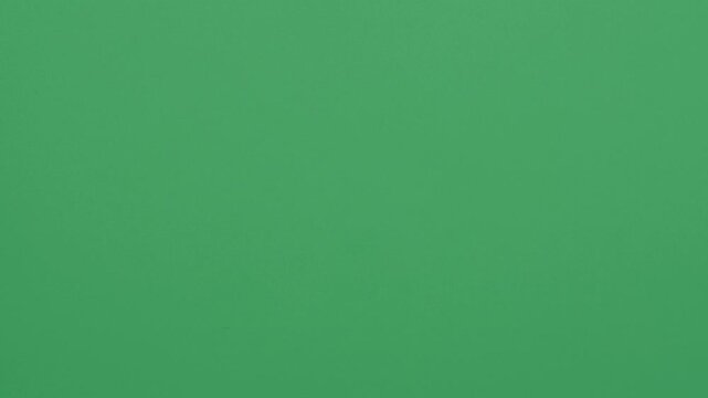 Stop motion animation of crumpled pape on a green background