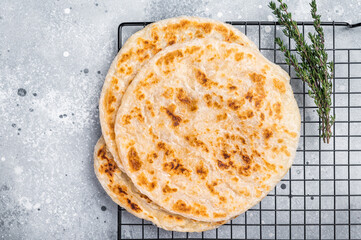 Homemade Kerala wheat paratha, layered parotta. grey background. top view